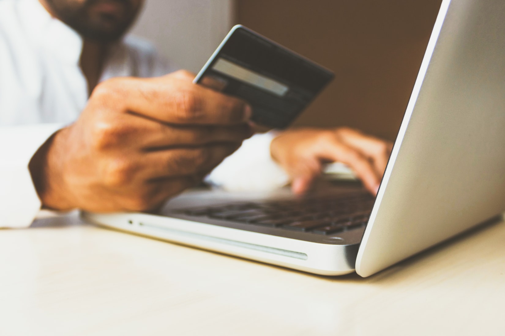 man with credit card and laptop